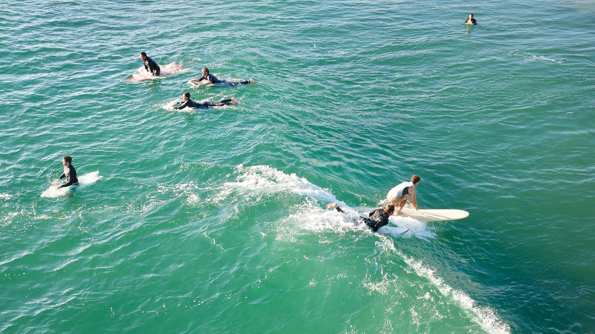 Surfers on a wave